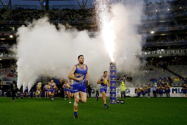 Jeremy McGovern of the Eagles leads the team out onto the field during the 2021 AFL Round 17 match between the West Coast Eagles and the North...