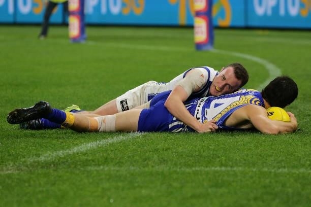 Liam Duggan of the Eagles is tackled by Jack Mahony of the Kangaroos during the 2021 AFL Round 17 match between the West Coast Eagles and the North...