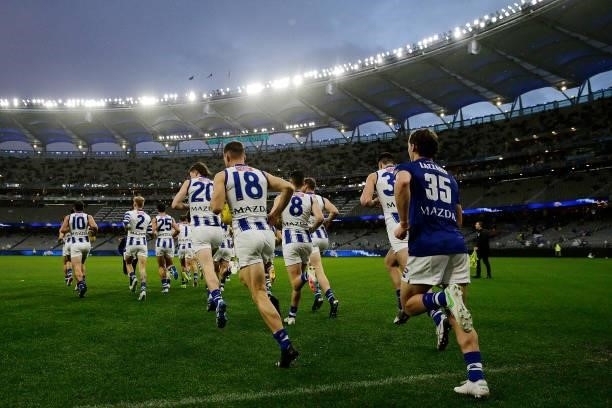 The Kangaroos run out onto the field during the 2021 AFL Round 17 match between the West Coast Eagles and the North Melbourne Kangaroos at Optus...