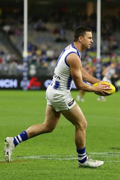 Luke Davies-Uniacke of the Kangaroos looks to pass the ball during the 2021 AFL Round 17 match between the West Coast Eagles and the North Melbourne...