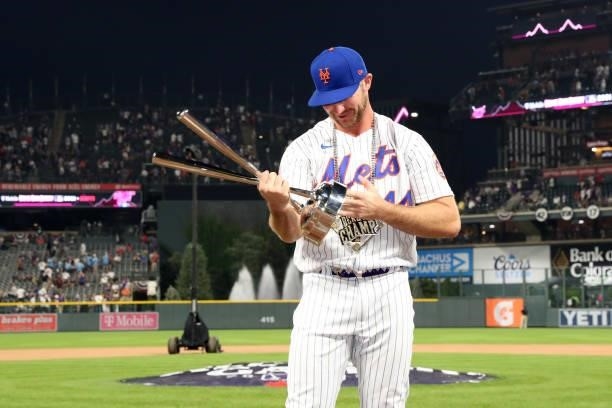 Pete Alonso of the New York Mets looks at the Home Run Derby championship trophy after winning the 2021 T-Mobile Home Run Derby at Coors Field on...