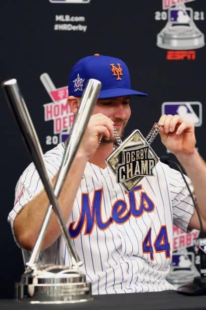 Pete Alonso of the New York Mets shows off his necklace as he speaks to the media after winning his second straight home run derby title during the...