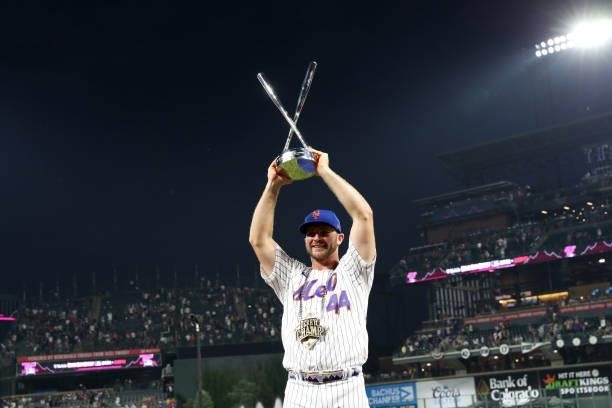 Pete Alonso of the New York Mets holds up the Home Run Derby championship trophy after winning the 2021 T-Mobile Home Run Derby at Coors Field on...
