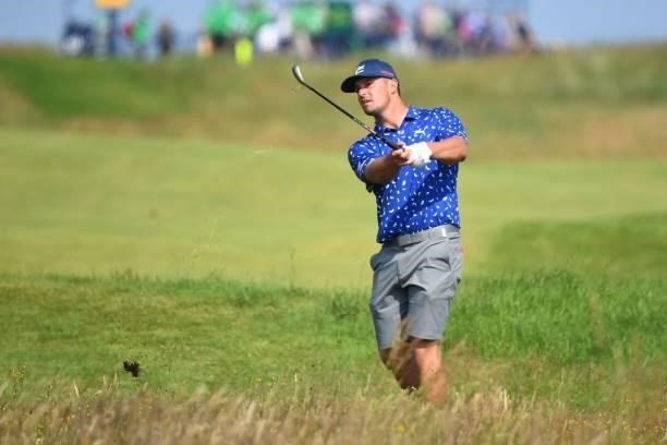 Golfer Bryson DeChambeau plays from the rough on the 18th hole during a practice round for The 149th British Open Golf Championship at Royal St...