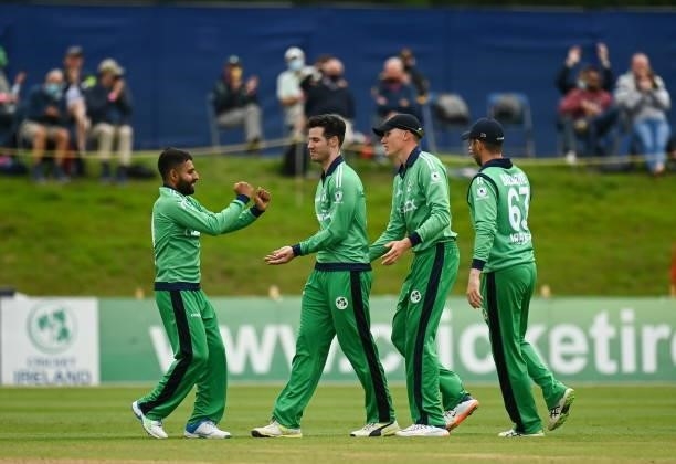 Dublin , Ireland - 13 July 2021; George Dockrell of Ireland, second left, celebrates the wicket of Janneman Malan of South Africa with team-mates...