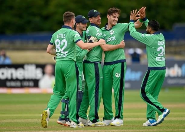 Dublin , Ireland - 13 July 2021; Mark Adair of Ireland, second right, is congratulated by team-mates after claiming the final wicket in their side's...