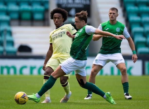 Arsenal's Willian is challenge by Scott Allan of Hibernian during a pre-season friendly between Hibernian and Arsenal at Easter Road, on July 13 in...