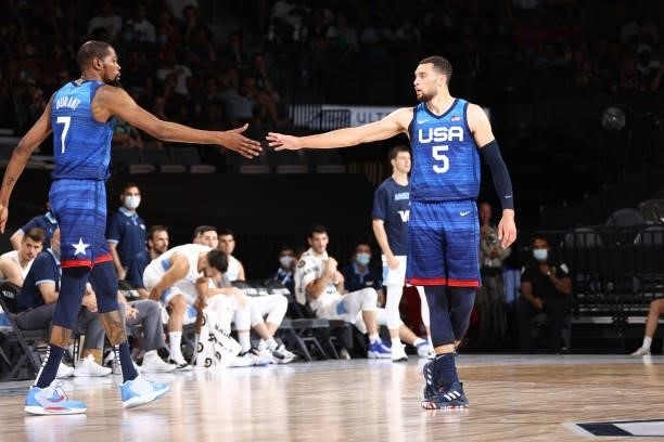 Zach LaVine of the USA Men's National Team high fives Kevin Durant of the USA Men's National Team during the game against the Argentina Men's...