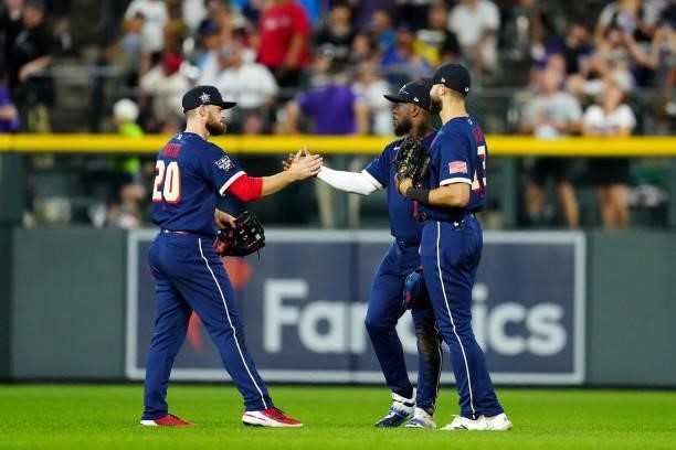 Jared Walsh of the Los Angeles Angels celebrates with Adolis Garcia and Joey Gallo of the Texas Rangers after the American League defeated the...