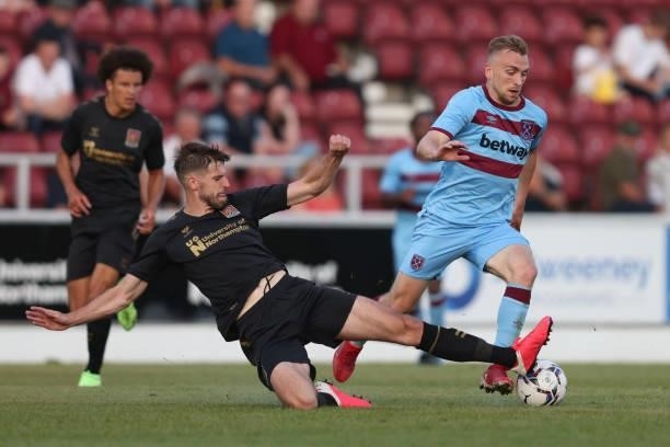 Jarrod Bowen of West Ham United in action with Jon Guthrie of Northampton Town during the Pre-season friendly between Northampton Town and West Ham...