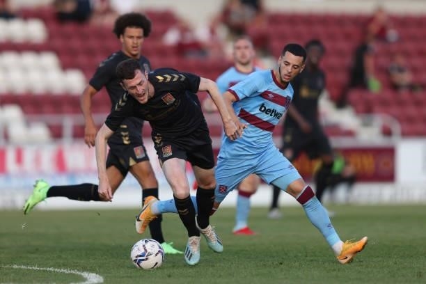 Nathan Holland of West Ham United in action with Paul Lewis of Northampton Town during the Pre-season friendly between Northampton Town and West Ham...