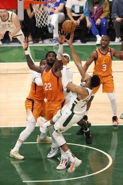 Giannis Antetokounmpo of the Milwaukee Bucks shoots the ball during the game against Deandre Ayton of the Phoenix Suns during Game Four of the 2021...