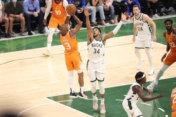 Chris Paul of the Phoenix Suns shoots the ball during the game against Giannis Antetokounmpo of the Milwaukee Bucks during Game Four of the 2021 NBA...