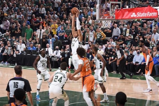 Giannis Antetokounmpo of the Milwaukee Bucks rebounds the ball during the game against the Phoenix Suns during Game Four of the 2021 NBA Finals on...