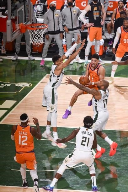 Devin Booker of the Phoenix Suns looks to pass the ball during the game against the Milwaukee Bucks during Game Four of the 2021 NBA Finals on July...