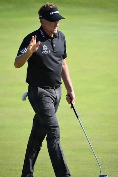 England's Ian Poulter reacts after holing his birdie putt on the 6th green during his first round on day one of The 149th British Open Golf...