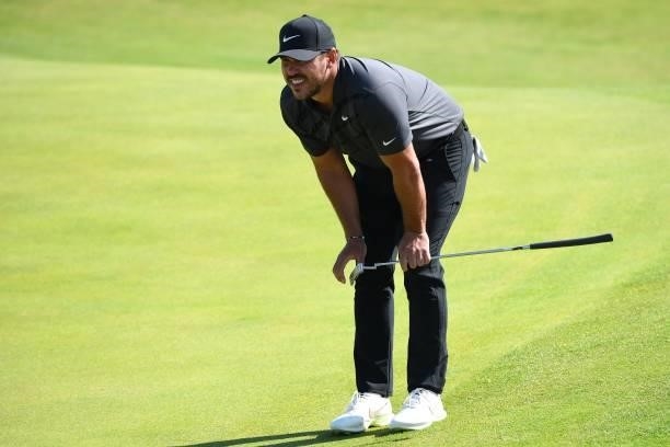 Golfer Brooks Koepka lines up his putt on the 6th green during his first round on day one of The 149th British Open Golf Championship at Royal St...
