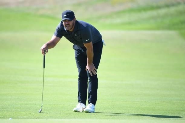 Golfer Brooks Koepka lines up a putt on the 7th green during his first round on day one of The 149th British Open Golf Championship at Royal St...