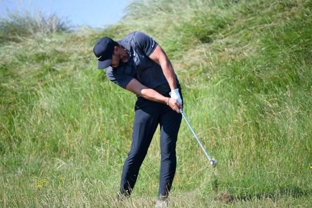Golfer Brooks Koepka plays from the rough on the 7th hole during his first round on day one of The 149th British Open Golf Championship at Royal St...