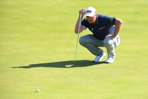 Golfer Jason Kokrak lines up his putt on the 6th green during his first round on day one of The 149th British Open Golf Championship at Royal St...