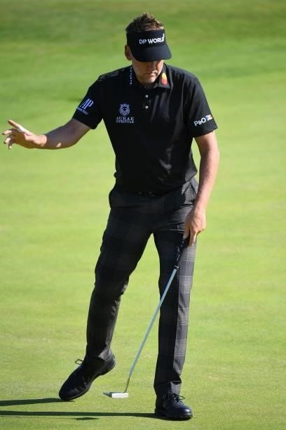England's Ian Poulter reacts after holing his birdie putt on the 6th green during his first round on day one of The 149th British Open Golf...