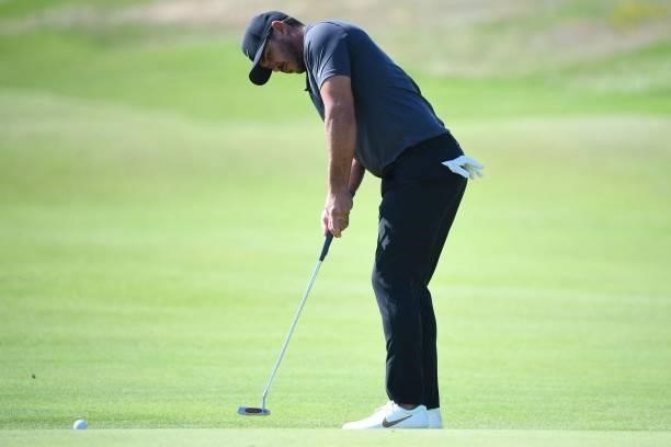 Golfer Brooks Koepka putts on the 7th green during his first round on day one of The 149th British Open Golf Championship at Royal St George's,...