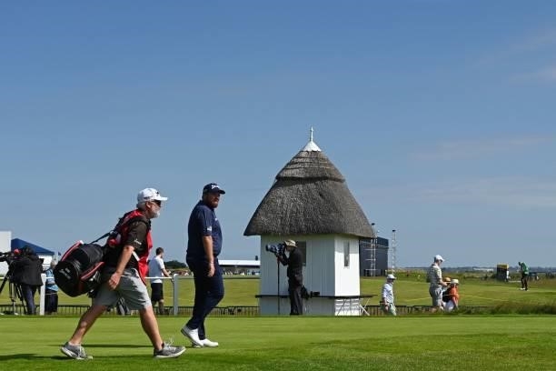 Ireland's Shane Lowry and caddie Brian Martin walk from the 1st tee during his first round on day one of The 149th British Open Golf Championship at...
