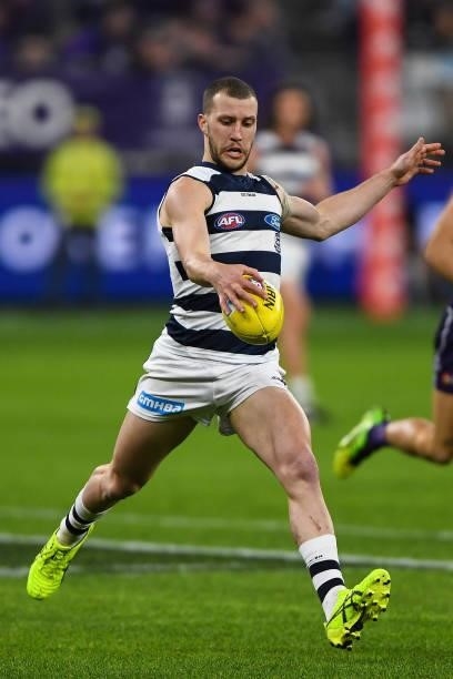 Sam Menegola of the Cats kicks the ball during the 2021 AFL Round 18 match between the Fremantle Dockers and the Geelong Cats at Optus Stadium on...