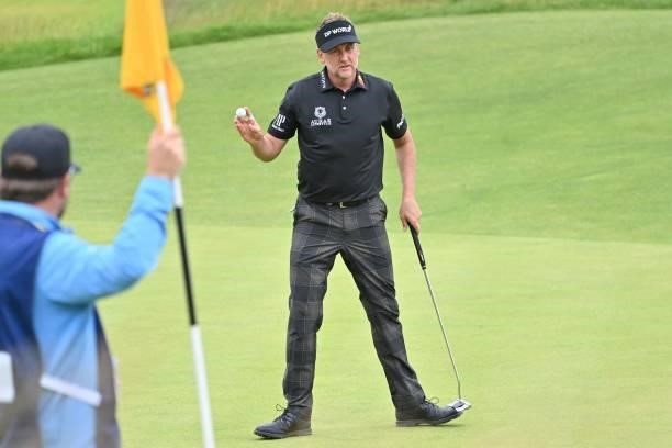 England's Ian Poulter acknowledges the applause after making a birdie on the 16th green during his first round on day one of The 149th British Open...