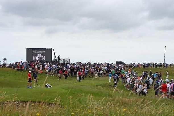 Spectators watch play around the 16th green on the opening day of The 149th British Open Golf Championship at Royal St George's, Sandwich in...