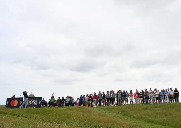 Spectators watch US golfer Jason Kokrak play from the 17th tee during his first round on day one of The 149th British Open Golf Championship at Royal...