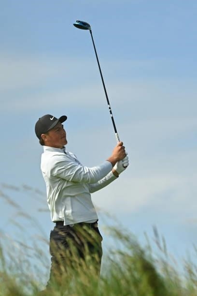 Argentina's amateur golfer Abel Gallegos watches his drive from the 13th tee during his first round on day one of The 149th British Open Golf...