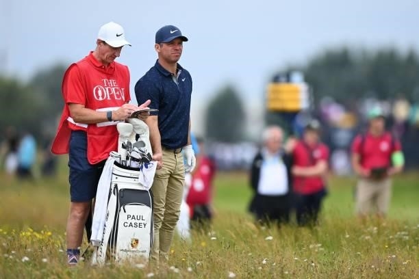 England's Paul Casey and his caddie John McLaren in the rough on the 15th hole during his first round on day one of The 149th British Open Golf...