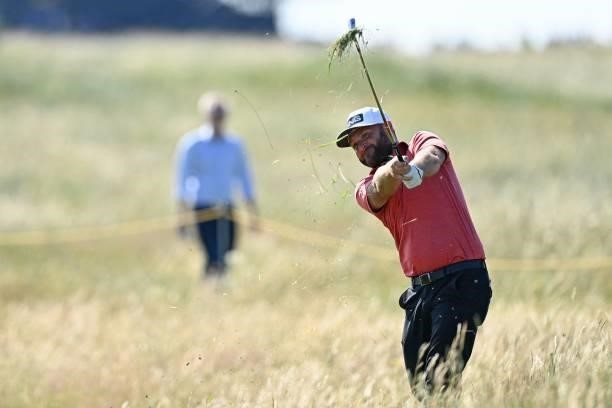 England's Andy Sullivan plays from the rough on the 12th hole during his first round on day one of The 149th British Open Golf Championship at Royal...