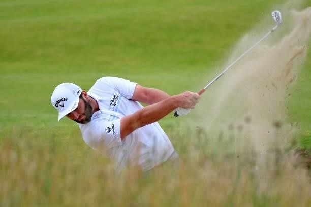 Spain's Jon Rahm plays from a bunker on the 9th hole during his first round on day one of The 149th British Open Golf Championship at Royal St...