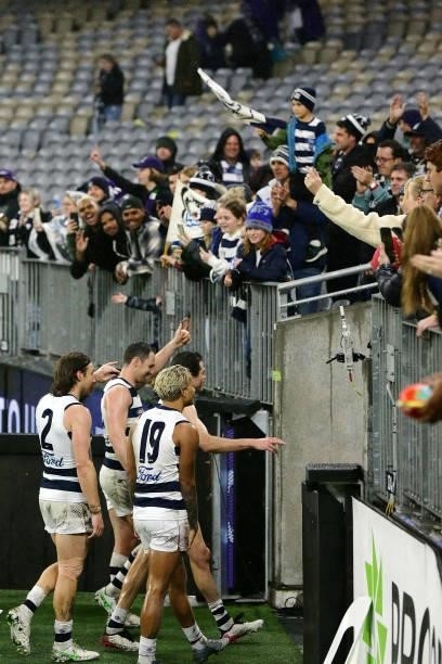 The Cats celebrate after the teams win during the 2021 AFL Round 18 match between the Fremantle Dockers and the Geelong Cats at Optus Stadium on July...