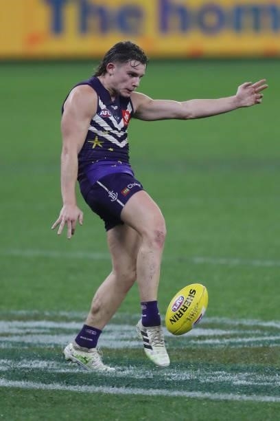 Caleb Serong of the Dockers kicks the ball during the 2021 AFL Round 18 match between the Fremantle Dockers and the Geelong Cats at Optus Stadium on...