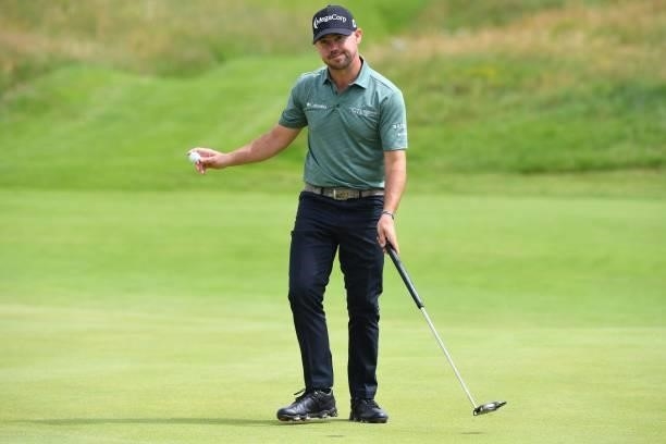 Golfer Brian Harman reacts after making his birdie putt on the 8th green during his first round on day one of The 149th British Open Golf...