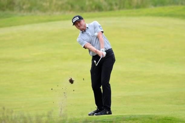 Canada's Mackenzie Hughes plays his approach shot to the 9th green during his first round on day one of The 149th British Open Golf Championship at...