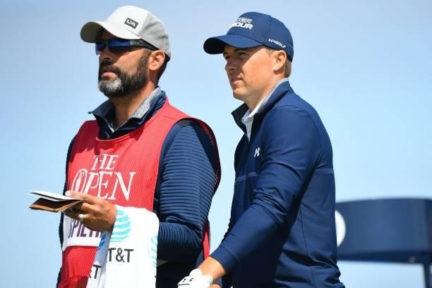 Golfer Jordan Spieth speaks with his caddie Michael Greller on the 8th tee during his first round on day one of The 149th British Open Golf...