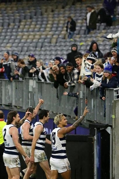 The Cats celebrate after the teams win during the 2021 AFL Round 18 match between the Fremantle Dockers and the Geelong Cats at Optus Stadium on July...