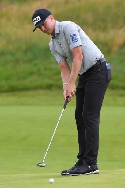 Canada's Mackenzie Hughes putts on the 8th green during his first round on day one of The 149th British Open Golf Championship at Royal St George's,...