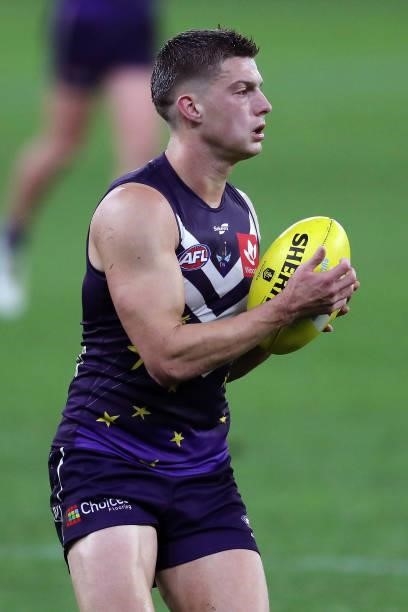 Darcy Tucker of the Dockers looks to pass the ball during the 2021 AFL Round 18 match between the Fremantle Dockers and the Geelong Cats at Optus...