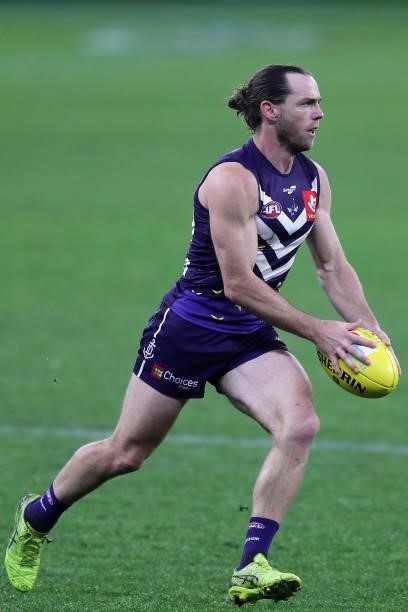Travis Colyer of the Dockers looks to pass the ball during the 2021 AFL Round 18 match between the Fremantle Dockers and the Geelong Cats at Optus...
