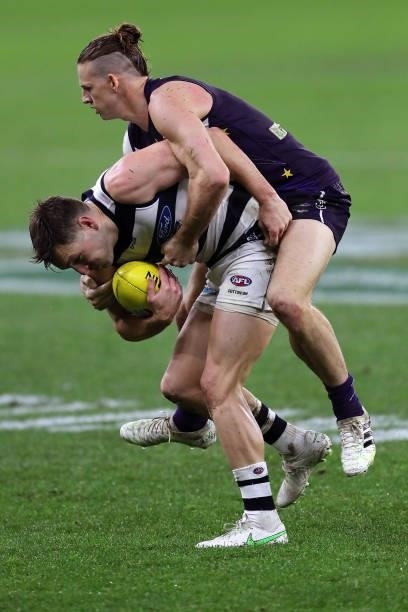 Shaun Higgins of the Cats is tackled by Nat Fyfe of the Dockers during the 2021 AFL Round 18 match between the Fremantle Dockers and the Geelong Cats...