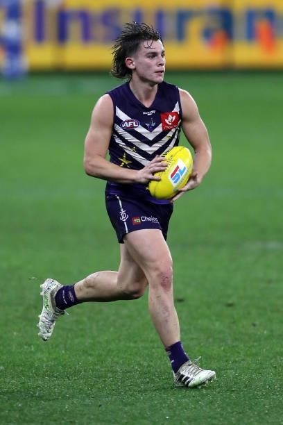 Caleb Serong of the Dockers runs with the ball during the 2021 AFL Round 18 match between the Fremantle Dockers and the Geelong Cats at Optus Stadium...