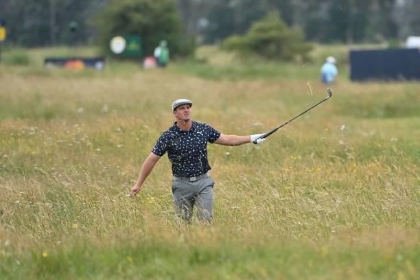 Golfer Bryson DeChambeau gestures from the deep rough on the 15th hole during his first round on day one of The 149th British Open Golf Championship...