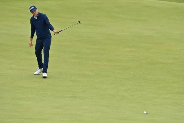 Golfer Jordan Spieth reacts after making his birdie putt on the 16th green during his first round on day one of The 149th British Open Golf...