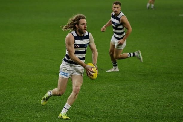 Cameron Guthrie of the Cats looks to pass the ball during the 2021 AFL Round 18 match between the Fremantle Dockers and the Geelong Cats at Optus...