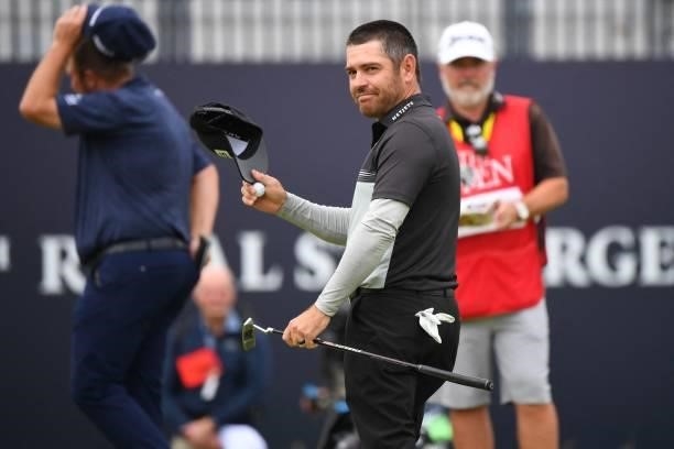 South Africa's Louis Oosthuizen reacts on the 18th green after his first round 64 on day one of The 149th British Open Golf Championship at Royal St...